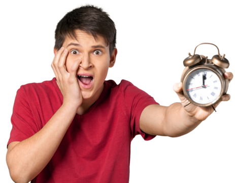 Portrait of scared young man holding clock and looking at camera with facial expression isolated on white