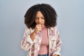 Fototapeta na wymiar Young african american woman standing over blue background feeling unwell and coughing as symptom for cold or bronchitis. health care concept.
