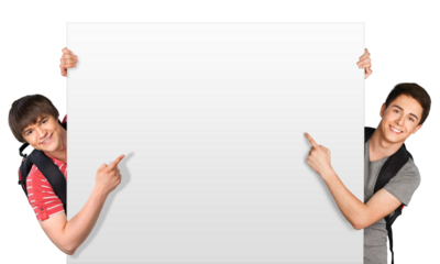 Smiling teenagers holding at a blank board