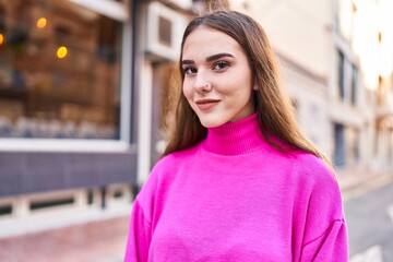 Young woman smiling confident standing at street