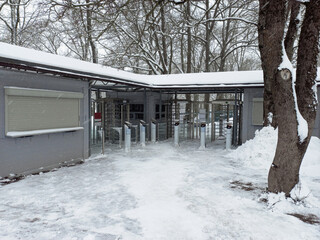 Turnstile, restricted entry. Closed gate exit to the street in winter.
