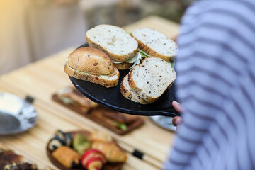 Preparing breakfast meal. Bread slices with butter, jam and cheese on white plate.