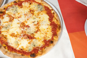 Margherita pizza or Margarita pizza on wooden background. Top view homemade fresh Italian Margherita or Margarita pizza with cheese, gourmet, basil. Pizza is traditional food for Italian on Italy.