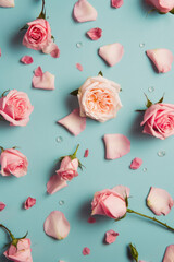 Pastel spring tender background, fresh pink field flowers, roses, petals and leaves flat lay with copy space. Generative AI.