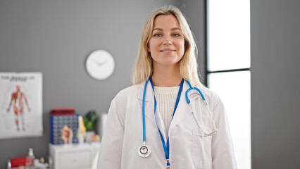 Young blonde woman doctor smiling confident standing at clinic