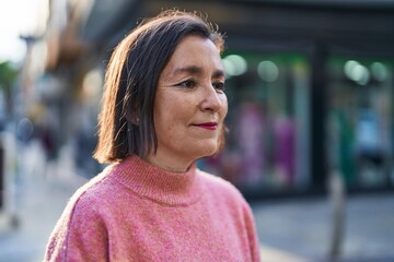 Middle age woman smiling confident standing at street
