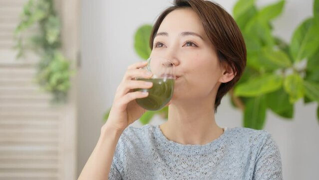 青汁を飲む若い女性　飲食イメージ	
