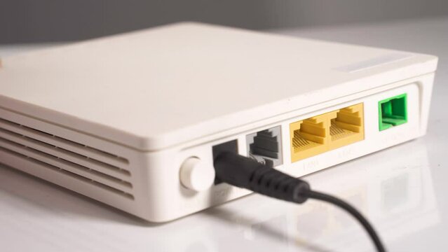 Man hand disconnect internet cable from socket router