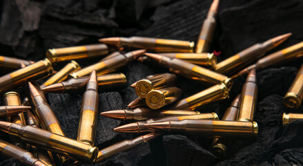 Cartridges for automatic carbine caliber .223 on charcoal. Ammunition for automatic and...