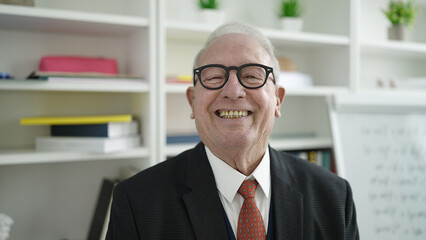senior smiling confident wearing glasses at university classroom