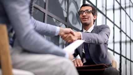 Shot of businessmen making a deal after viewing a document