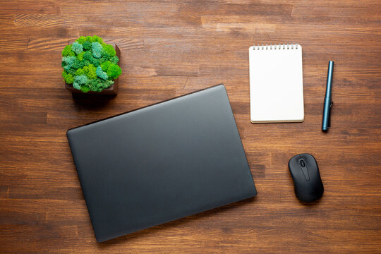 Flat lay photo of Office table with laptop computer, notebook, digital tablet, Pencil on wooden background. Desktop office mockup concept.