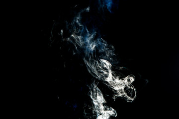 Smoke effect texture. Isolated background. Black and dark backdrop. Smokey fire and mistic effect.