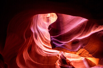 Antelope Canyon in the Navajo Reservation Page Northern Arizona. Famous slot canyon. Light showing off the glamorous detail of the ancient spiral rock arches. Multicolored texture, rock formation. 