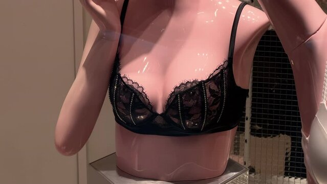 Lace black bra worn on a woman's mannequin in a lingerie store window