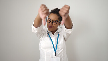 African american woman doing negative gesture with thumbs down over isolated white background