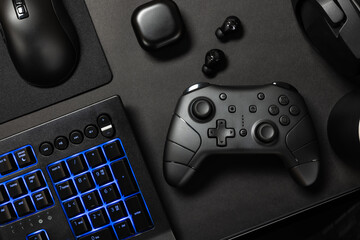Top view of various modern gaming devices with blue lit keyboard