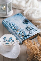 still life acup of coffee, book,flowers