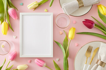 Women's Day concept. Top view photo of white photo frame plates cutlery knife fork fabric napkin with gold ring empty glasses tulips flowers and small hearts baubles on pastel pink background