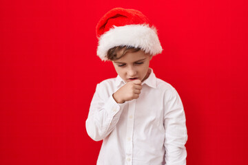 Little caucasian boy wearing christmas hat over red background feeling unwell and coughing as symptom for cold or bronchitis. health care concept.