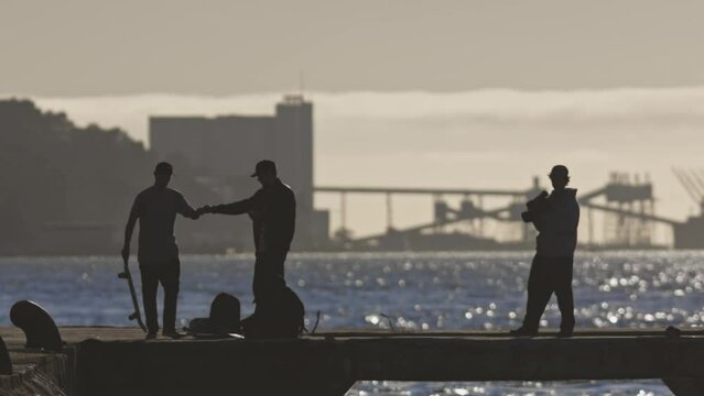 Skateboarders hang out on the waterfront