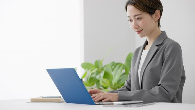 ノートパソコンを使う若い女性　ビジネスイメージ	
