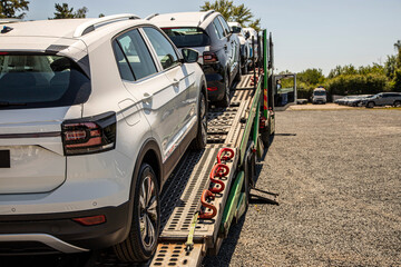 New white crossover - SUV on car carrier trailer, car-carrying trailer, car hauler, auto transport...