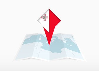 Malta is depicted on a folded paper map and pinned location marker with flag of Malta.
