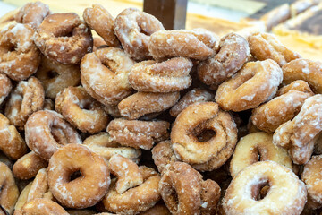 A close-up of traditional Spanish homemade fried donuts covered in sugar, fresh from the market, a sweet treat