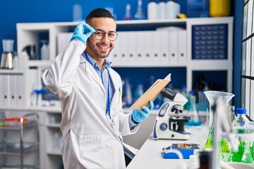 African american man scientist reading book working at laboratory