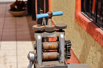An old manual machine for rolling gold and silver