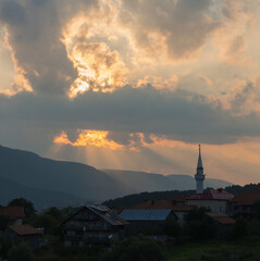 Obraz premium Sunset over the town of Sarnitsa, located in the Western Rhodope Mountains near the Dospat Reservoir.