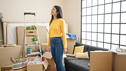 Young beautiful hispanic woman smiling confident standing at new home