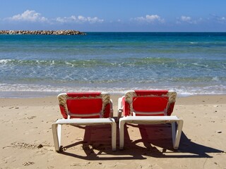 Chairs and lounges at the spectacular sandy beach of Netanya, Israel. Mediterranean coast on a sunny day