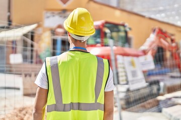 Young hispanic man architect standing on back view at park