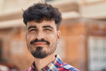 Fototapeta premium Young hispanic man smiling confident standing at street