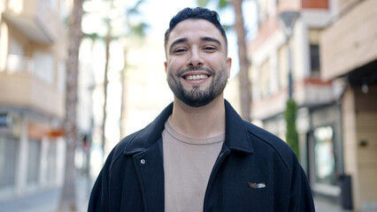 Young arab man smiling confident standing at street