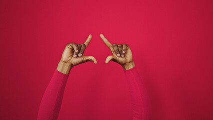African american woman doing frame gesture with hands at street