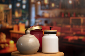 Mugs of sugar and salt containers style vintage over a table in night restaurant with selective focus and bokeh background