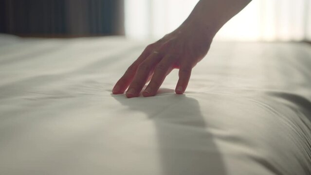 B roll - Close up hand of woman dragging on clean white bed gently with relax, Slow motion