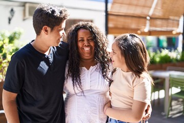 African american family hugging each other at street