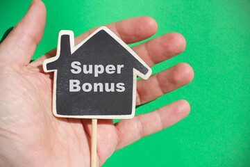 Hand holding a house with the sign 