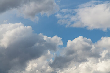 Beautiful huge fluffy clouds on the blue sky. Sky clouds background.