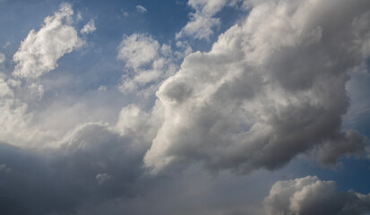 Beautiful huge fluffy clouds on the blue sky. Sky clouds background.