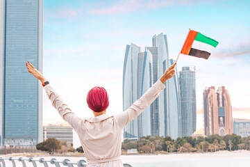 citizen woman stands tall with the UAE flag, exemplifying the strong cultural and historical ties...