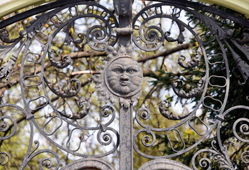 Antique heraldic sun symbol on the entrance to the central park.