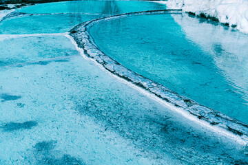 hot spring limestone white pools, hydrothermal or geothermal springs in pamukkale, Turkey natural heritage, winter season view