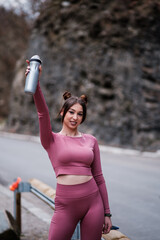 Young Woman Smiling While Exercising in Pink Sports Clothing