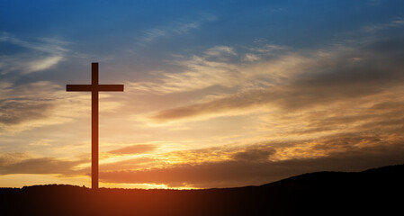 Christian cross on hill outdoors at sunrise. Resurrection of Jesus. Concept photo.