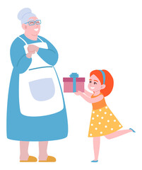 Girl giving present to grandmother. Holiday celebration gift